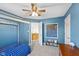 Blue bedroom with a bed, chalkboard wall, and open doorway to hallway at 17849 Grassy Knoll Dr, Westfield, IN 46074