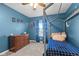 bedroom with blue walls, a bed, dresser, and space-themed decor at 17849 Grassy Knoll Dr, Westfield, IN 46074