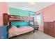 Bunk beds in a teal and pink bedroom with wooden dresser, chair, and window at 17849 Grassy Knoll Dr, Westfield, IN 46074