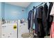 Laundry room with washer, dryer, and hanging rack, blue wall with laundry decal at 17849 Grassy Knoll Dr, Westfield, IN 46074