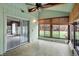 Sunroom with tile floors, ceiling fan, and sliding glass doors to backyard at 2025 Hamilton Ln, Carmel, IN 46032