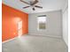 Spacious bedroom with orange accent wall and window at 2291 Creek Bank Dr, Columbus, IN 47201