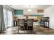 Dining area with wood-look floors, an accent wall, and a fish tank at 2678 Odell St, Brownsburg, IN 46112