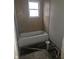Small bathroom with tan tiled walls and a bathtub at 2702 Boulevard Pl, Indianapolis, IN 46208