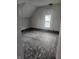 Unfinished bedroom with exposed wood floors and a window at 2702 Boulevard Pl, Indianapolis, IN 46208