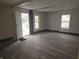Living room with gray flooring, open doorway and two windows at 2702 Boulevard Pl, Indianapolis, IN 46208