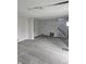 Spacious living room with gray vinyl flooring and exposed ceiling beams at 2702 Boulevard Pl, Indianapolis, IN 46208