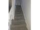 Gray carpeted staircase with white railings at 2702 Boulevard Pl, Indianapolis, IN 46208