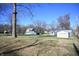 Large backyard with mature trees and a detached garage at 3235 Adams St, Indianapolis, IN 46218