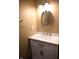 Updated bathroom with white vanity and oval mirror at 3235 Adams St, Indianapolis, IN 46218