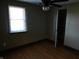 Bedroom with wood-look floors, ceiling fan, and closet at 3235 Adams St, Indianapolis, IN 46218