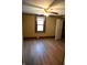 Bedroom with hardwood floors, window, and ceiling fan at 3235 Adams St, Indianapolis, IN 46218
