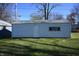 Detached garage with a side door and window at 3235 Adams St, Indianapolis, IN 46218