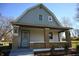 Nice gray house with a brick porch and well-maintained landscaping at 3235 Adams St, Indianapolis, IN 46218