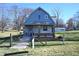 Cute gray house with a large yard and a charming front porch at 3235 Adams St, Indianapolis, IN 46218