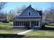 Two-story home with gray siding and a porch at 3235 Adams St, Indianapolis, IN 46218