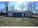 Detached garage with white door and gray exterior at 3235 Adams St, Indianapolis, IN 46218
