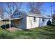 Beige and gray garage with covered carport at 3235 Adams St, Indianapolis, IN 46218