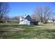 Back of the house showing a screened porch and large yard at 3235 Adams St, Indianapolis, IN 46218