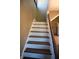 Wooden staircase with white risers and dark treads at 3235 Adams St, Indianapolis, IN 46218