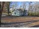 Side view of the house showing backyard and wooded area at 3340 N Franklin Rd, Indianapolis, IN 46226