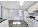 Modern kitchen features white cabinets, new appliances, and vinyl plank flooring at 355 Mcclure Rd, Columbus, IN 47201