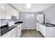 Bright eat-in kitchen with white cabinets, new appliances, and dark countertops at 355 Mcclure Rd, Columbus, IN 47201