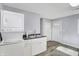 Laundry room with stackable washer/dryer, utility sink, and white cabinets at 355 Mcclure Rd, Columbus, IN 47201