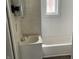 Bathroom with a tub, sink, and tiled walls at 430 S Proud St, Muncie, IN 47305
