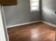 Empty bedroom with hardwood floors and a window at 430 S Proud St, Muncie, IN 47305
