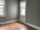 Spacious bedroom with hardwood floors and two windows at 430 S Proud St, Muncie, IN 47305