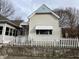Charming light beige house with a white picket fence at 430 S Proud St, Muncie, IN 47305