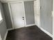 Laundry area with dark hardwood floors and exterior access at 430 S Proud St, Muncie, IN 47305