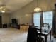 Open dining area adjacent to the living room, featuring a wooden dining table and large windows at 6171 E Newberry Ct, Camby, IN 46113