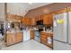 Galley style kitchen with wood cabinets and stainless steel appliances at 6171 E Newberry Ct, Camby, IN 46113