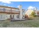 Back view of townhome showcasing patio and landscaping at 6454 Bay Harbor Ln, Indianapolis, IN 46254