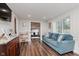 Finished basement space with blue sofa, wooden cabinet, and view of ' area at 7375 N Kitley Ave, Indianapolis, IN 46250