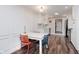 Dining area with white table and colorful chairs, open to the updated kitchen at 7375 N Kitley Ave, Indianapolis, IN 46250