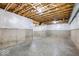 Unfinished basement with exposed beams and plumbing at 7650 Clarion Dr, Indianapolis, IN 46236