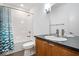Clean bathroom with tub shower and wood vanity at 7650 Clarion Dr, Indianapolis, IN 46236