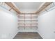 Walk-in closet with ample shelving and hanging space at 7650 Clarion Dr, Indianapolis, IN 46236