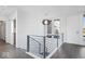 Modern staircase and hallway with sleek metal railing and hardwood floors at 7650 Clarion Dr, Indianapolis, IN 46236