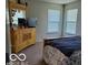 Bedroom with dresser, large windows, and a bed at 7720 Bolero Dr, Camby, IN 46113