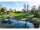 Aerial view of lakefront property showing expansive lawn and dock at 9454 Raintree S Dr, Columbus, IN 47201