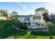 Aerial view of house, deck, and lakefront property with beautiful fall foliage at 9454 Raintree S Dr, Columbus, IN 47201
