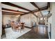Open concept dining room with hardwood floors, exposed beams, and a view of the entry at 9454 Raintree S Dr, Columbus, IN 47201