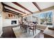 Bright dining room with hardwood floors, fireplace, and large windows offering scenic views at 9454 Raintree S Dr, Columbus, IN 47201