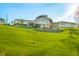 Stunning lakefront home with expansive lawn and tiered landscaping at 9454 Raintree S Dr, Columbus, IN 47201