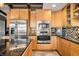 Modern kitchen with stainless steel appliances and light wood cabinets at 9454 Raintree S Dr, Columbus, IN 47201