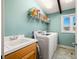 Laundry room with washer, dryer, and ample storage at 9454 Raintree S Dr, Columbus, IN 47201
